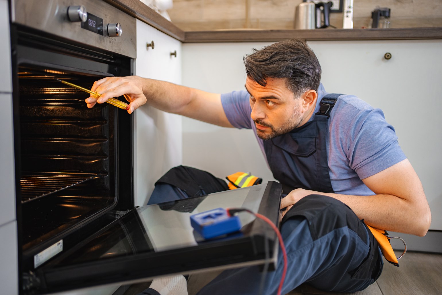 George's Master Technician Repairing Home Oven